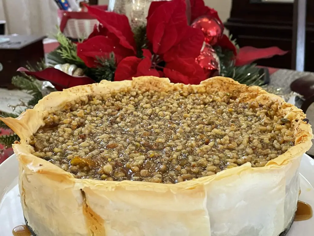Homemade Baklava Cheesecake with honey syrup, walnuts and pistachio