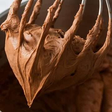 Fluffy milk chocolate whipped ganache frosting on a whisk – perfect texture for cupcakes or cakes