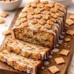 cinnamon toast crunch bread sliced with vanilla glaze and cinnamon cereal topping on a wooden board