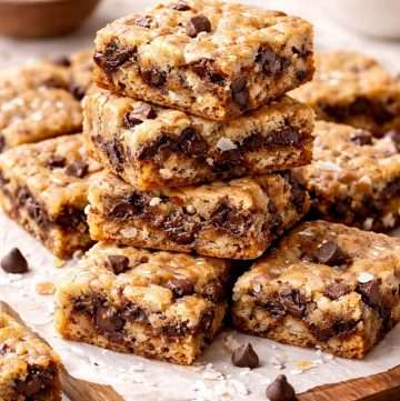Dark chocolate coconut blondies with chewy centers, visible dark chocolate chunks, and shredded coconut