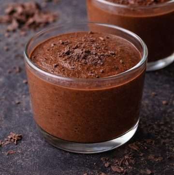Two glass cups of Portuguese chocolate mousse made with dark chocolate, smooth and creamy texture, served chilled