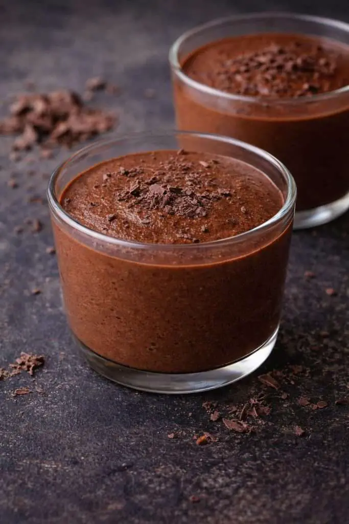 Two glass cups of Portuguese chocolate mousse made with dark chocolate, smooth and creamy texture, served chilled