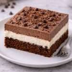 italian love cake slice on a plate showing chocolate cake ricotta layer and chocolate pudding topping