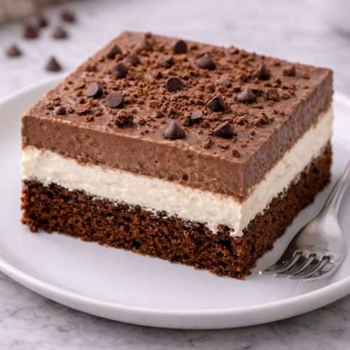 italian love cake slice on a plate showing chocolate cake ricotta layer and chocolate pudding topping
